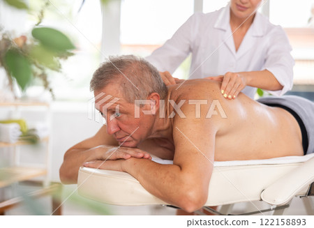 male patient having massage male patient having massage 122158893