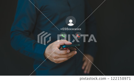 Person answering the incoming call. Phone call was from an unknown number. Call center gang or stranger. Hoax person with a fake identity. Concept of scam, fraud with a phone from the scammer. Person answering the incoming call. Phone call was from an unknown number. Call center gang or stranger. Hoax person with a fake identity. Concept of scam, fraud with a phone from the scammer. 122158971