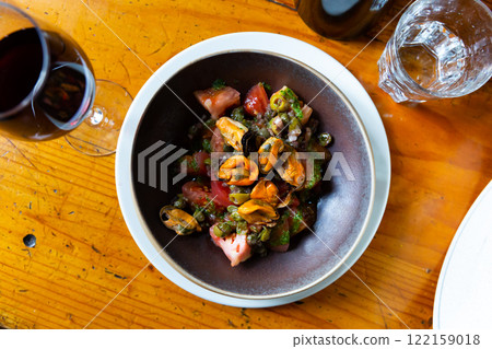 Tomatoes with arugula pesto and mussels served on plate Tomatoes with arugula pesto and mussels served on plate 122159018