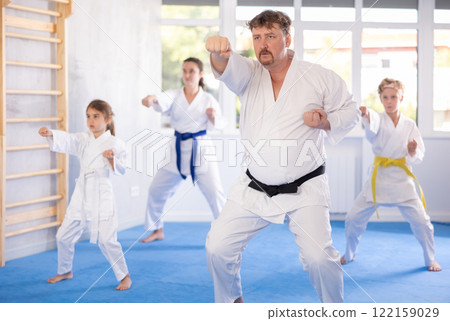 Family with children training karate techniques Family with children training karate techniques 122159029