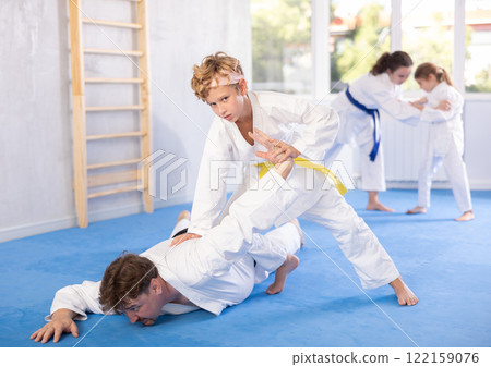 Father and son training judo fighting techniques 122159076