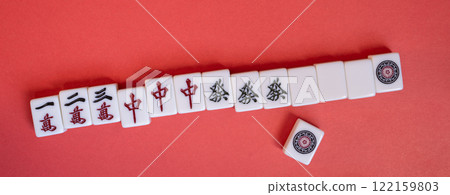 Mahjong tiles on a red background Mahjong tiles on a red background 122159803