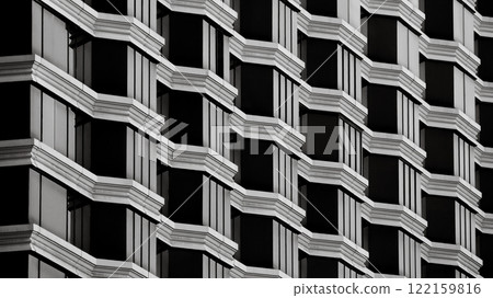 a repetitive architectural facade with geometric patterns of black and white, creating a striking and symmetrical composition. a repetitive architectural facade with geometric patterns of black and white, creating a striking and symmetrical composition. 122159816