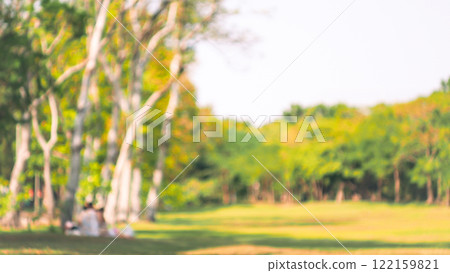 a serene park setting, with a soft focus on trees and a grassy area, adding a warm and tranquil vibe. The blur creates an inviting atmosphere, perfect for relaxation. a serene park setting, with a soft focus on trees and a grassy area, adding a warm and tranquil vibe. The blur creates an inviting atmosphere, perfect for relaxation. 122159821