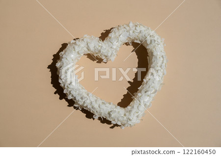 Heart made of white lilac flowers on pastel beige background. Still life romantic composition of Valentines day holiday copy space for your text invitation greeting card Heart made of white lilac flowers on pastel beige background. Still life romantic composition of Valentines day holiday copy space for your text invitation greeting card 122160450