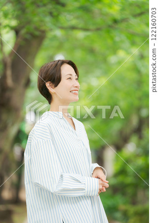 A woman relaxing in the fresh greenery 122160703
