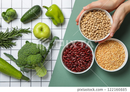 Set of vegetarian protein products and female hands on green and white background, top view 122160885