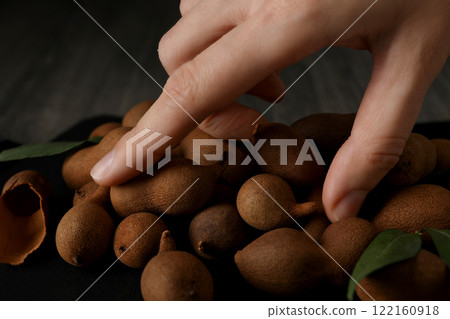 Ripe tamarind on a black board on a dark background 122160918