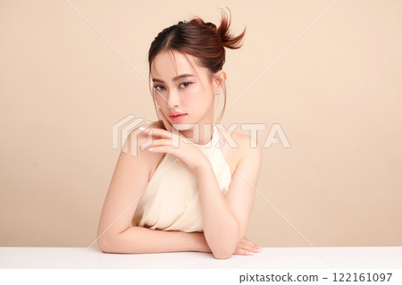 Beautiful young asian woman with clean fresh skin on beige background, Face care, Facial treatment, Cosmetology, beauty and spa, Asian women portrait. Beautiful young asian woman with clean fresh skin on beige background, Face care, Facial treatment, Cosmetology, beauty and spa, Asian women portrait. 122161097