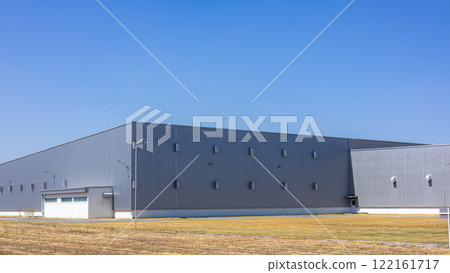 Modern Industrial Warehouse Exterior on a Sunny Day, Factory industry, Warehouse Construction in Geometric Modern Design, Backdrop Wall Metal Corrugated Steel Surface Pattern. 122161717