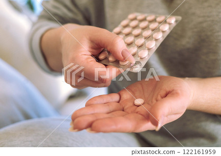 Woman is going to take medicine for headache, stomach or vitamin and food supplements. Woman is going to take medicine for headache, stomach or vitamin and food supplements. 122161959