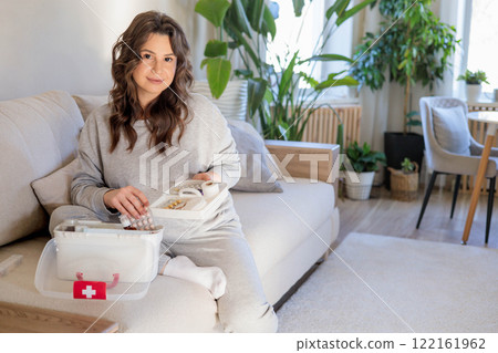 Female housewife checking medicines at domestic first aid kit neatly placing storage organization. Female housewife checking medicines at domestic first aid kit neatly placing storage organization. 122161962