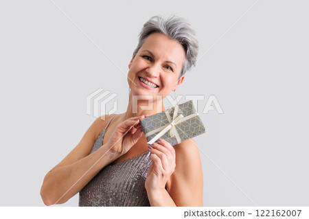 Beautiful happy middle-aged elderly woman with gray short hair smiling and looking at camera 122162007