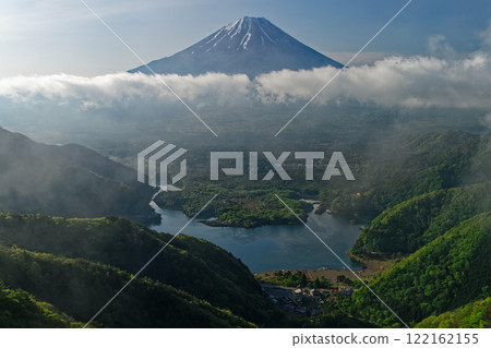 Lake Shoji and Mt. Fuji in the morning mist, seen from the green Sanpobun mountain ridge Lake Shoji and Mt. Fuji in the morning mist, seen from the green Sanpobun mountain ridge 122162155