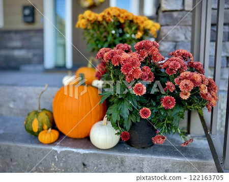 Pumpkin and chrysanthemums on the porch for Halloween Pumpkin and chrysanthemums on the porch for Halloween 122163705