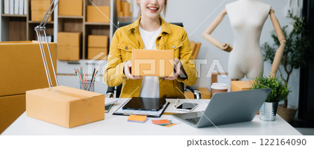 Startup small business SME, Entrepreneur owner woman using smartphone or tablet taking receive and checking online purchase shopping order Startup small business SME, Entrepreneur owner woman using smartphone or tablet taking receive and checking online purchase shopping order 122164090