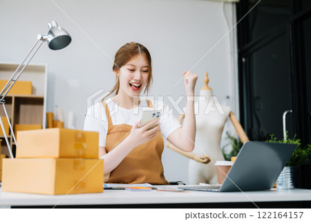 Young business owner woman prepare parcel box and standing check online orders for deliver to customer on tablet, laptop Young business owner woman prepare parcel box and standing check online orders for deliver to customer on tablet, laptop 122164157