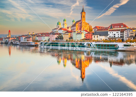 Passau, Germany. Waterfront sunset water reflection - old town cityscape with St. Stephan's Basilica and Danube River. Passau, Germany. Waterfront sunset water reflection - old town cityscape with St. Stephan's Basilica and Danube River. 122164395