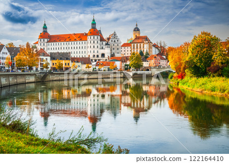 Neuburg an der Donau, Germany. Old town with Sclohss Neuburg and trees in autumn colors, Danube River water reflection, Bavaria beautiful small city. 122164410