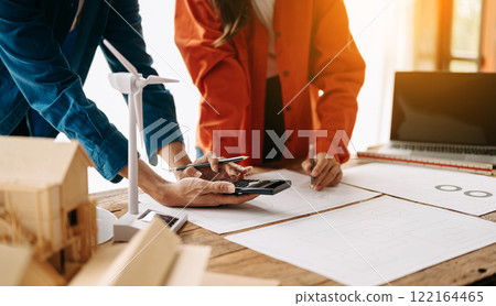 Creative architect projecting on the big drawings in the dark loft office Creative architect projecting on the big drawings in the dark loft office 122164465