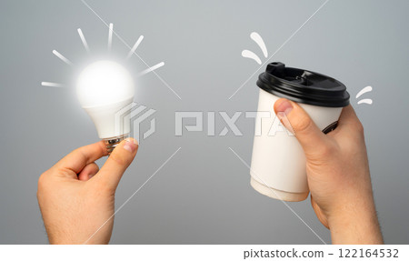 Glowing light bulb and paper coffee cup. Concept of an idea. Take a break and get inspired for a new idea. Talent for coming up with new things and innovative approaches. Creativity and inspiration. Glowing light bulb and paper coffee cup. Concept of an idea. Take a break and get inspired for a new idea. Talent for coming up with new things and innovative approaches. Creativity and inspiration. 122164532