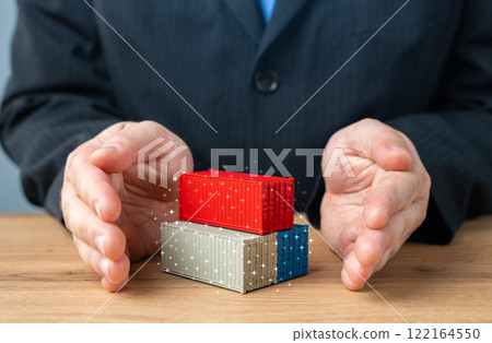 The businessman protects containers with his palms. Freight service and cargo support. Trade and economics. Import and export. Carriers and Shipping. The businessman protects containers with his palms. Freight service and cargo support. Trade and economics. Import and export. Carriers and Shipping. 122164550