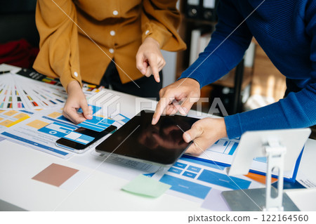 Close up view of UI developer team brainstorming on their project with laptop, smartphone and digital tablet. Creative digital development agency. 122164560
