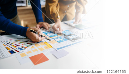 Close up view of UI developer team brainstorming on their project with laptop, smartphone and digital tablet. Creative digital development agency. 122164563