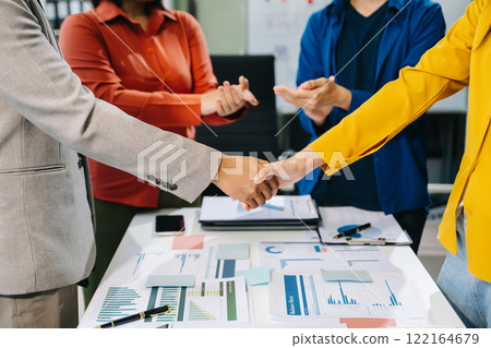 Two confident business man shaking hands during a meeting in the office, success, dealing 122164679