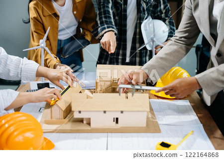 Engineer desk with object paper and tablet with blurry engineer teamwork hardworking 122164868