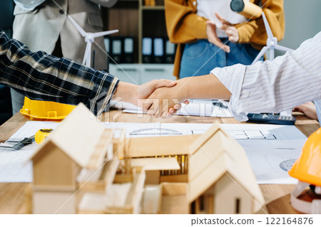 Engineer desk with object paper and tablet with blurry engineer teamwork hardworking Engineer desk with object paper and tablet with blurry engineer teamwork hardworking 122164876