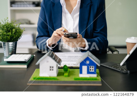 Real estate broker agent presenting and consult to customer to decision making sign insurance form agreement, home model, Real estate broker agent presenting and consult to customer to decision making sign insurance form agreement, home model, 122164879