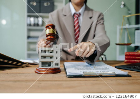 Real Estate Lawyer And House Foreclosure Law. House model, hammer judge gavel on table with white background. Foreclosure, bankruptcy concept 122164907