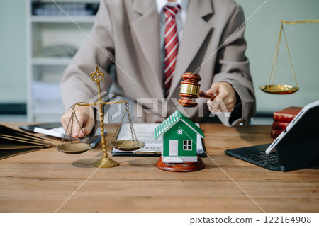 Real Estate Lawyer And House Foreclosure Law. House model, hammer judge gavel on table with white background. Foreclosure, bankruptcy concept 122164908