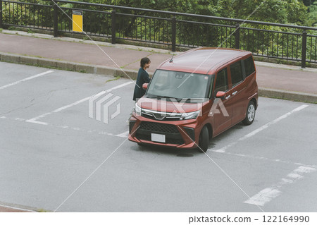 Woman returning to her car in the parking lot 122164990