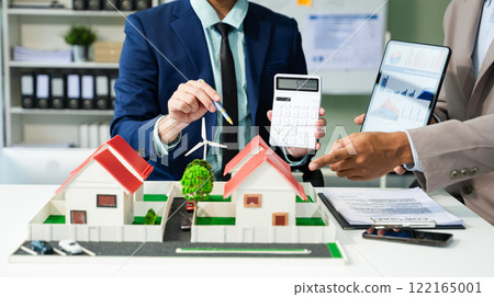 balancing the property sector The real estate agent is explaining the house style to see the house design and the purchase agreement. 122165001