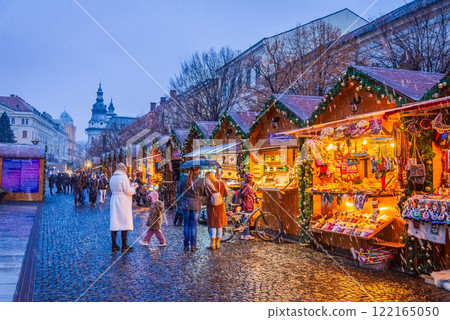 Cluj Christmas Market, illuminated stalls, holiday decorations, twinkling lights, cozy atmosphere, vibrant winter celebration in Transylvania, Romania. 122165050