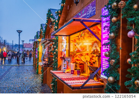 Cluj Christmas Market, illuminated stalls, holiday decorations, twinkling lights, cozy atmosphere, vibrant winter celebration in Transylvania, Romania. Cluj Christmas Market, illuminated stalls, holiday decorations, twinkling lights, cozy atmosphere, vibrant winter celebration in Transylvania, Romania. 122165054