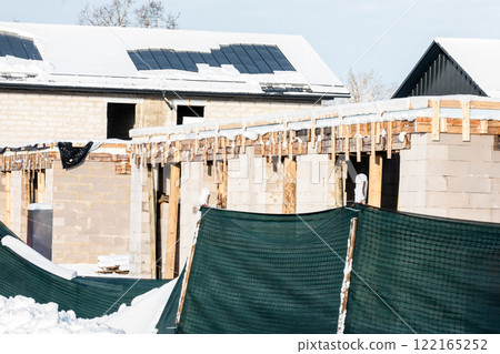Several newly built private houses at a fenced construction site 122165252