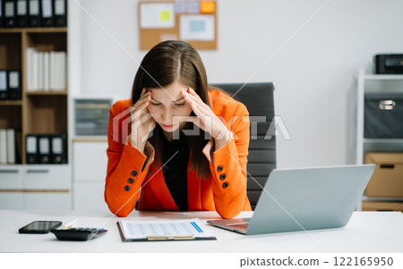 Overworked young Asian businesswoman office worker suffering from neck pain after had a long day at her office Overworked young Asian businesswoman office worker suffering from neck pain after had a long day at her office 122165950