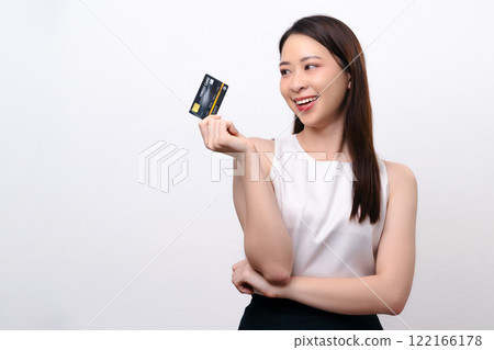 Beautiful businesswoman holding a credit card, smiling happily and cheerfully. Beautiful businesswoman holding a credit card, smiling happily and cheerfully. 122166178