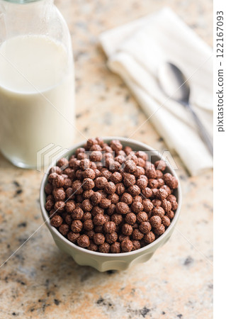 Breakfast cereal chocolate balls in bowl on kitchen table. Breakfast cereal chocolate balls in bowl on kitchen table. 122167093