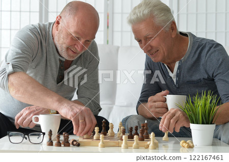 two old senior men playing chess at home two old senior men playing chess at home 122167461