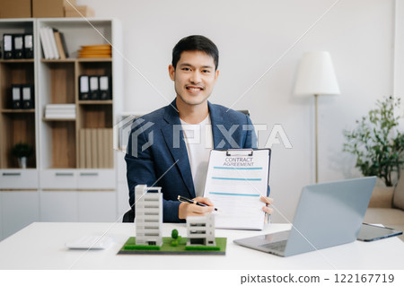 Considering buying a home, investing in real estate. Broker signs a sales agreement. agent, lease agreement, successful deal Considering buying a home, investing in real estate. Broker signs a sales agreement. agent, lease agreement, successful deal 122167719