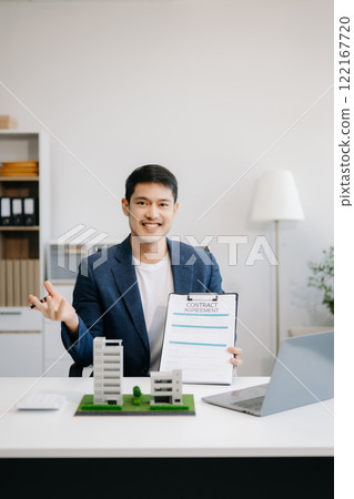 Considering buying a home, investing in real estate. Broker signs a sales agreement. agent, lease agreement, successful deal Considering buying a home, investing in real estate. Broker signs a sales agreement. agent, lease agreement, successful deal 122167720