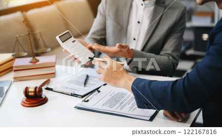 businessman or lawyer or accountant working on accounts using a smart phone laptop digital tablet calculator and documents\ 122167816