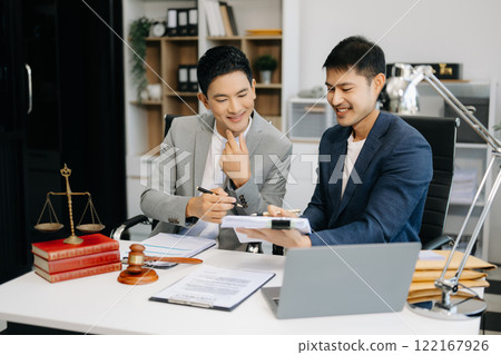 Asian business team and lawyers discussing contract papers sitting at the table. Concepts of law, advice, legal services. 122167926