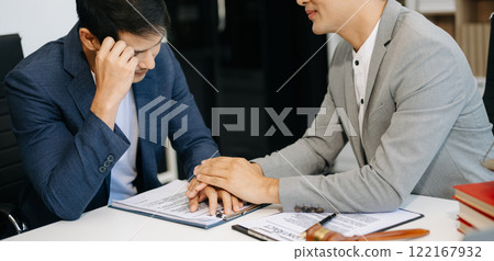 Judge gavel with scales of justice, Business and lawyer or counselor consulting and discussing contract papers with laptop and tablet at law firm 122167932