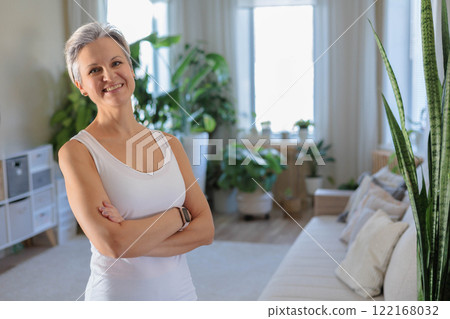 Beautiful gray haired mature woman with honed sport slim body posing.  122168032