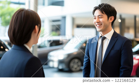 Young salesman at a car dealership Young salesman at a car dealership 122168129